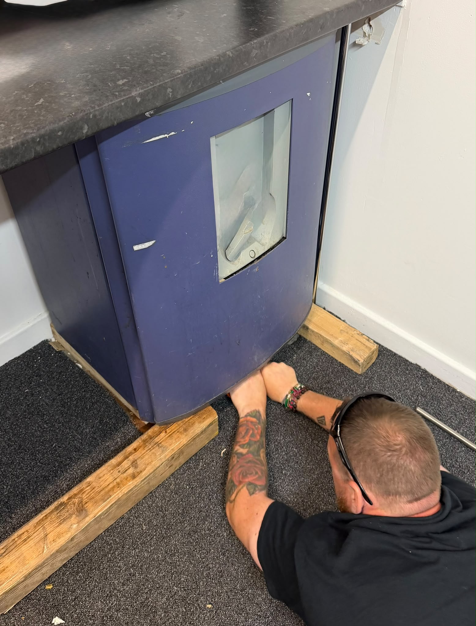 A safe being carefully prepared for removal inside a property