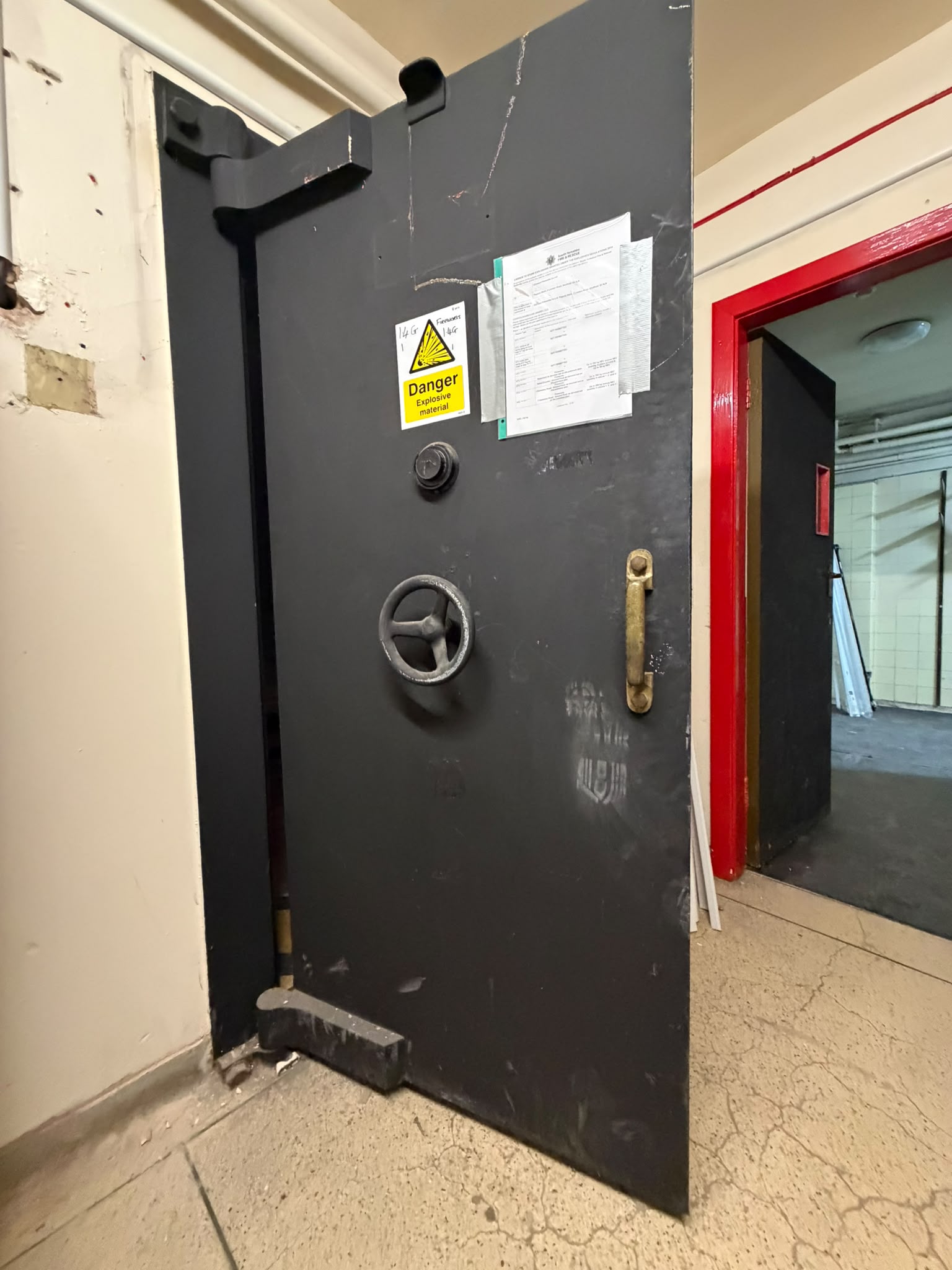 A heavy vault door inside a commercial security area
